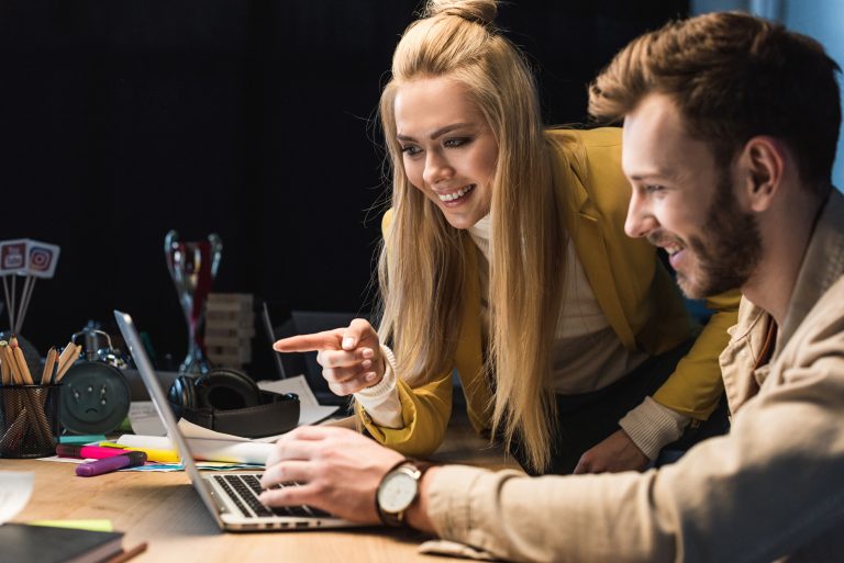 Agency owner and white label partner reviewing a project on a laptop